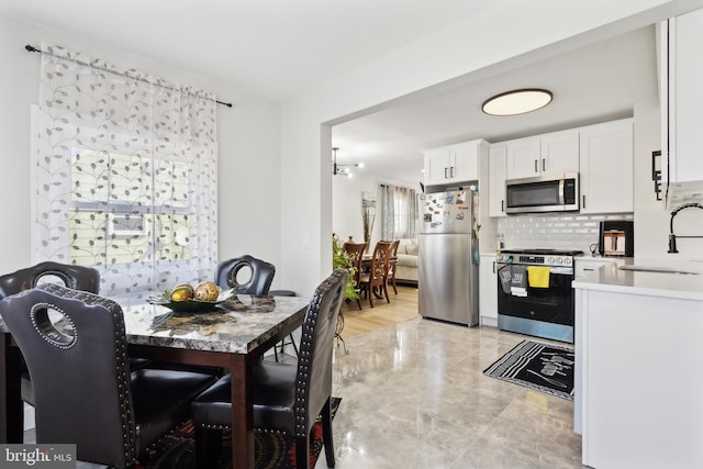 dining room featuring marble finish floor