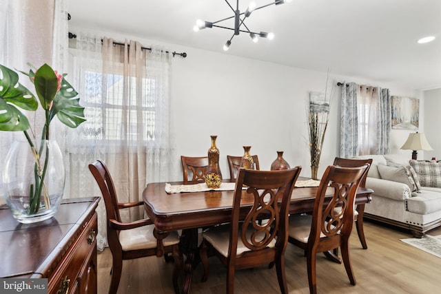 dining area featuring a chandelier and light wood-style flooring