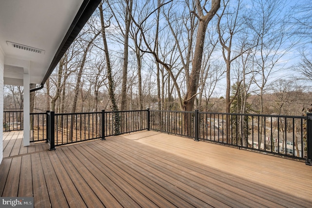 wooden terrace featuring visible vents