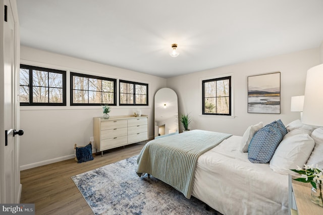 bedroom with baseboards and wood finished floors