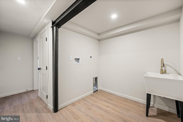 laundry area with light wood finished floors, hookup for a washing machine, hookup for an electric dryer, laundry area, and baseboards