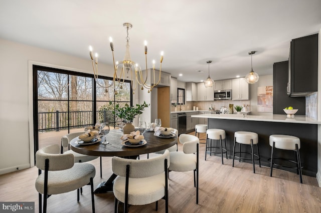 dining room featuring baseboards and light wood-style floors