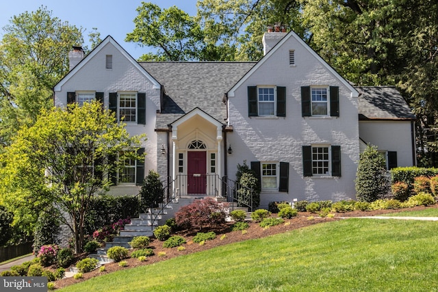 1911 Belle Haven Rd, Alexandria, VA 22307 - traditional-style home featuring a chimney, a front lawn, brick siding, and roof with shingles