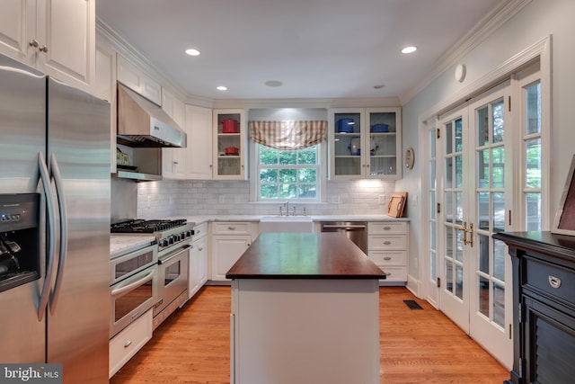 1911 Belle Haven Rd, Alexandria, VA 22307 - kitchen with stainless steel appliances, french doors, extractor fan, crown molding, and a sink