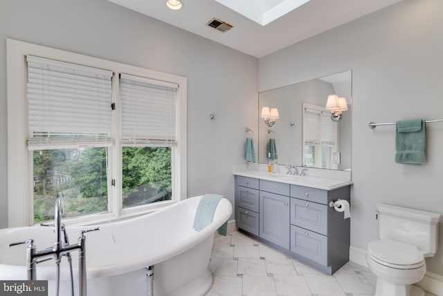 1911 Belle Haven Rd, Alexandria, VA 22307 - full bath featuring marble look tiles, a freestanding tub, toilet, vanity, and recessed lighting