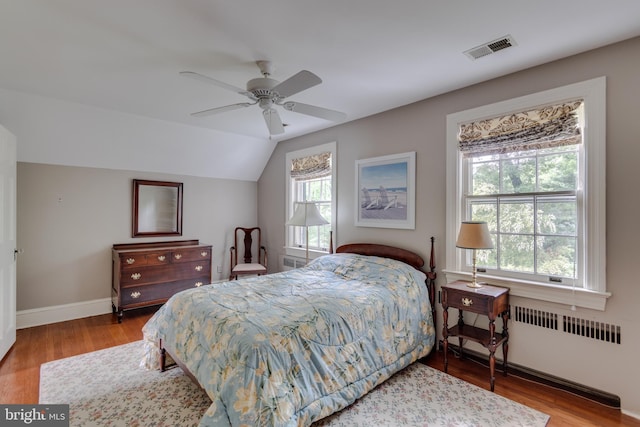 1911 Belle Haven Rd, Alexandria, VA 22307 - bedroom with radiator heating unit, multiple windows, wood finished floors, and lofted ceiling