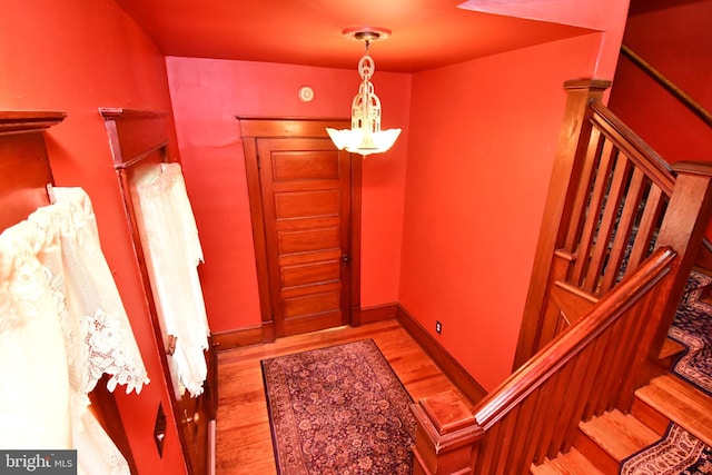 foyer featuring light wood finished floors and stairs