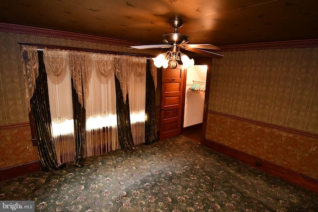 empty room with a ceiling fan and baseboards