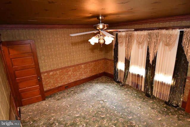 spare room featuring a ceiling fan and baseboards