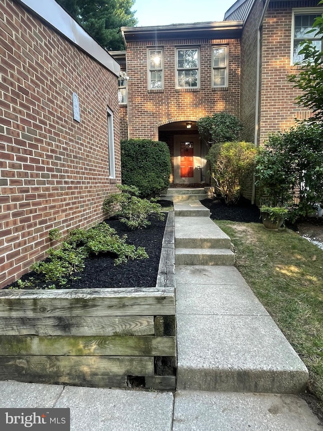 doorway to property with brick siding