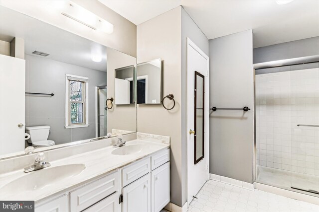 full bathroom featuring toilet, a stall shower, visible vents, and a sink