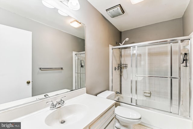 full bath featuring shower / bath combination with glass door, vanity, and toilet