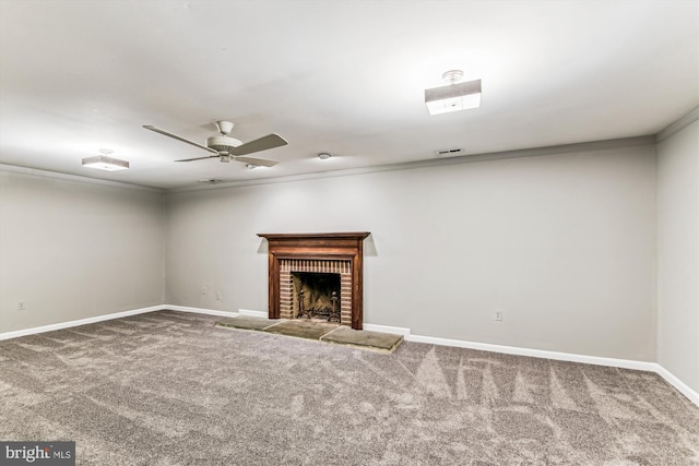 unfurnished living room featuring a fireplace, visible vents, baseboards, carpet, and crown molding