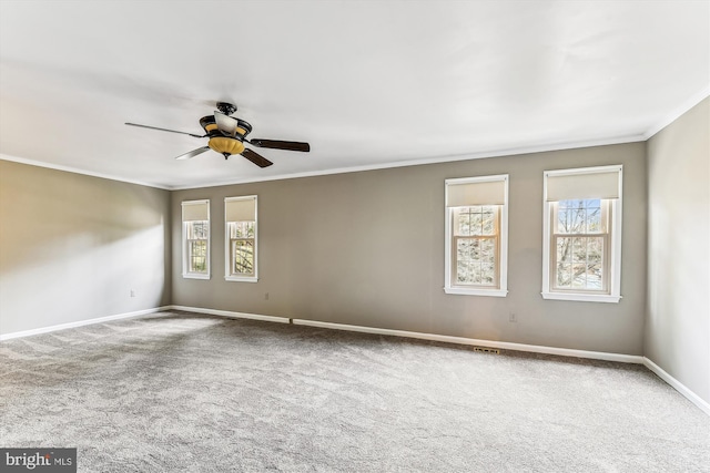 empty room with crown molding, carpet, and a healthy amount of sunlight