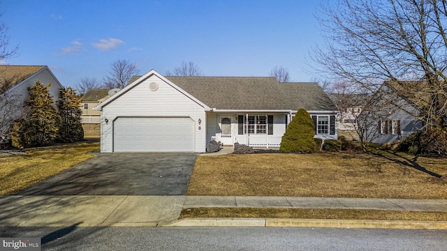 view of front facade with a garage, a front yard, roof with shingles, and aphalt driveway