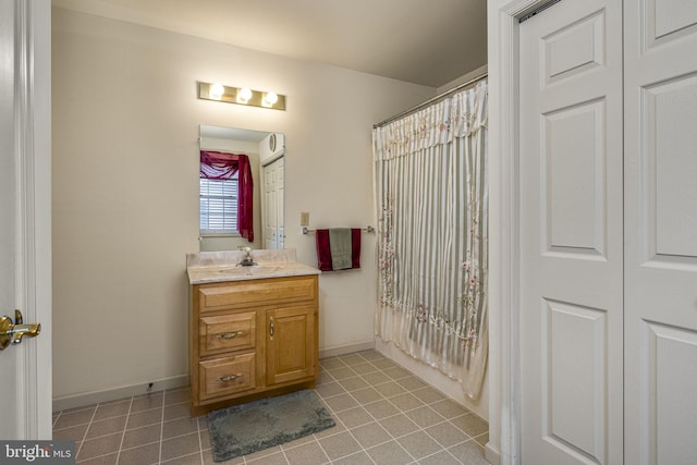 bathroom with baseboards, tile patterned floors, vanity, and a shower with curtain