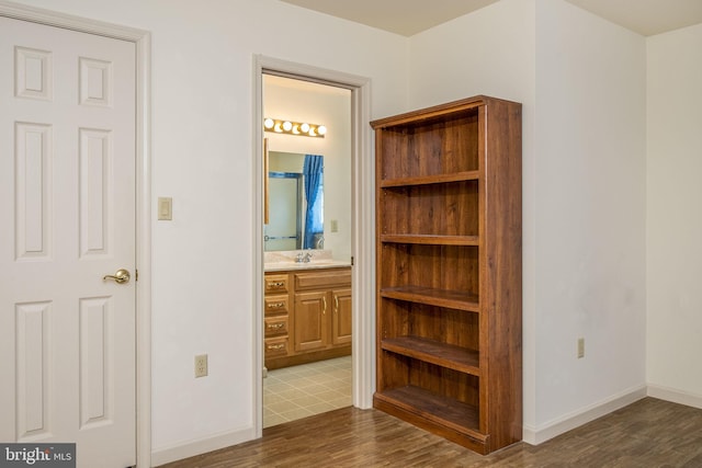 interior space featuring wood finished floors and baseboards