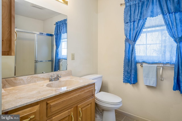 full bathroom with vanity, a shower stall, toilet, and tile patterned floors