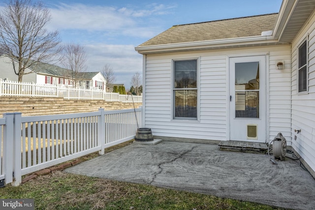 exterior space featuring a patio, roof with shingles, and fence