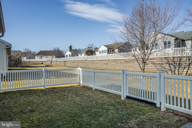 view of yard featuring a fenced backyard and a residential view