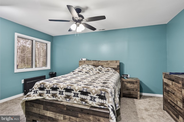 bedroom featuring a ceiling fan, carpet flooring, visible vents, and baseboards