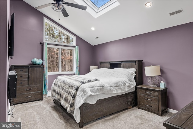 bedroom with baseboards, vaulted ceiling with skylight, visible vents, and light colored carpet