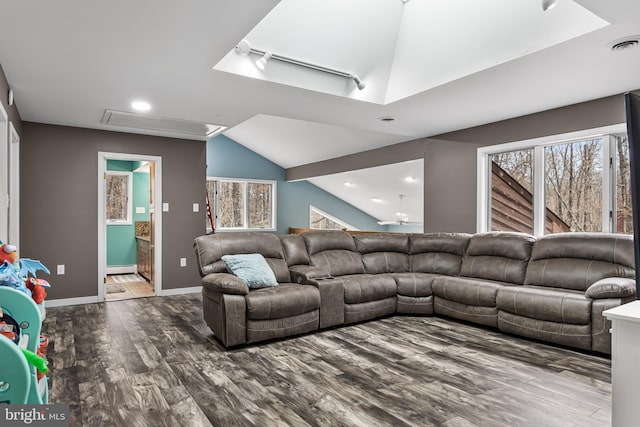 living room featuring baseboards, visible vents, lofted ceiling, wood finished floors, and baseboard heating