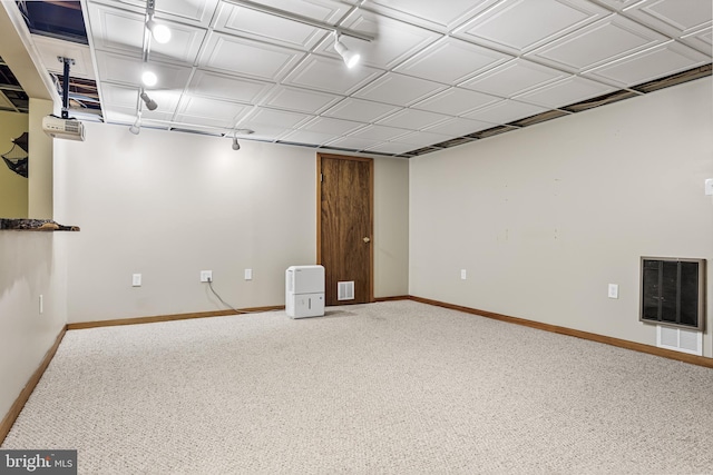 below grade area featuring carpet, visible vents, and baseboards