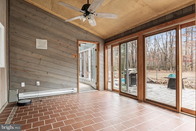 interior space featuring vaulted ceiling, ceiling fan, and baseboard heating