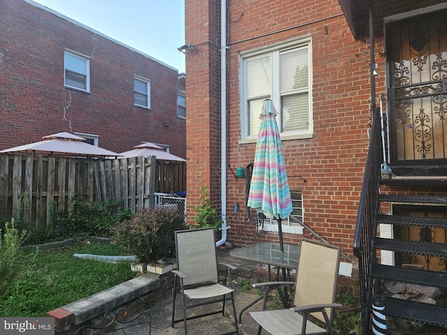 view of patio / terrace featuring fence