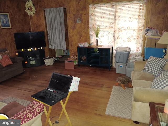 living room with wooden walls and wood finished floors