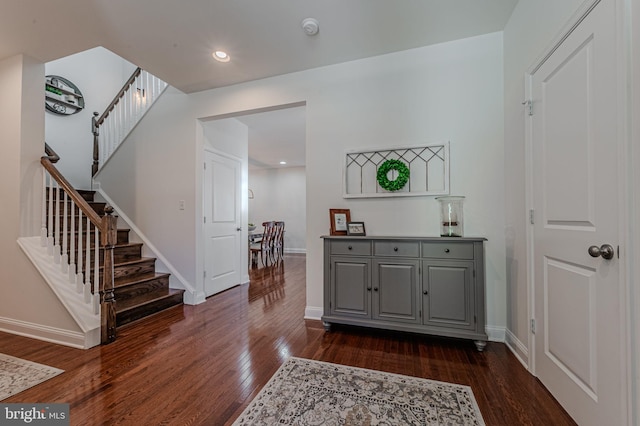 foyer with recessed lighting, dark wood-style flooring, stairway, and baseboards