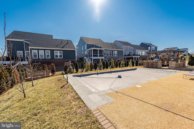 exterior space featuring a residential view and a yard