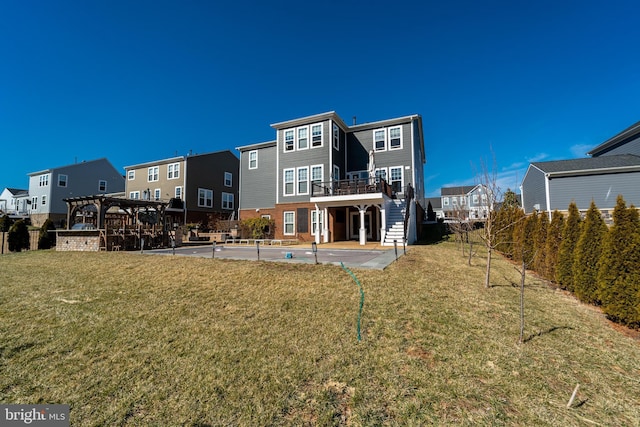 back of property with a lawn, a patio, stairway, a wooden deck, and a pergola