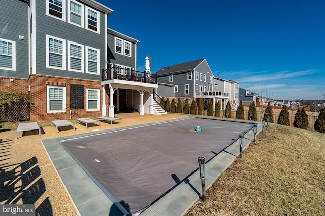 exterior space with stairs, fence, and a residential view