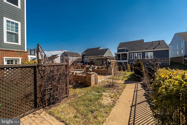 view of yard featuring fence and a residential view