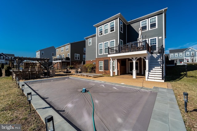 exterior space with a residential view, stairs, fence, a wooden deck, and brick siding