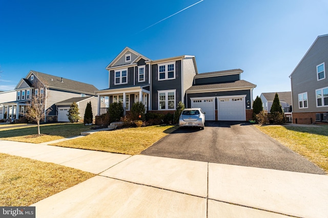 view of front facade with an attached garage, aphalt driveway, and a front yard