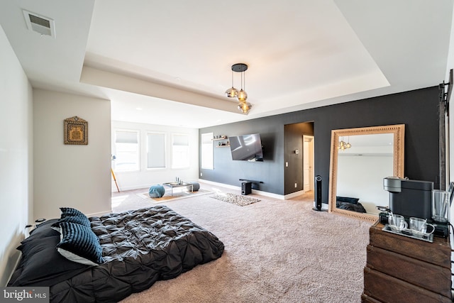 bedroom with baseboards, visible vents, a tray ceiling, and carpet flooring