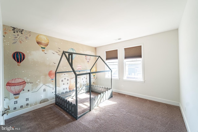 unfurnished bedroom featuring carpet floors, visible vents, and baseboards