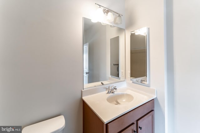 half bath with vanity and toilet