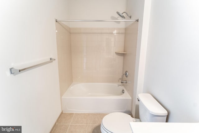 full bath with washtub / shower combination, toilet, and tile patterned floors