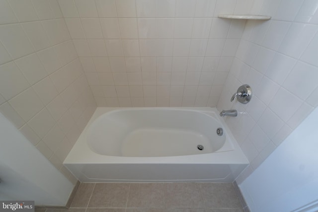 full bathroom featuring tile patterned flooring and bathing tub / shower combination