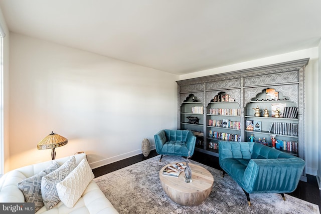 sitting room featuring baseboards and wood finished floors