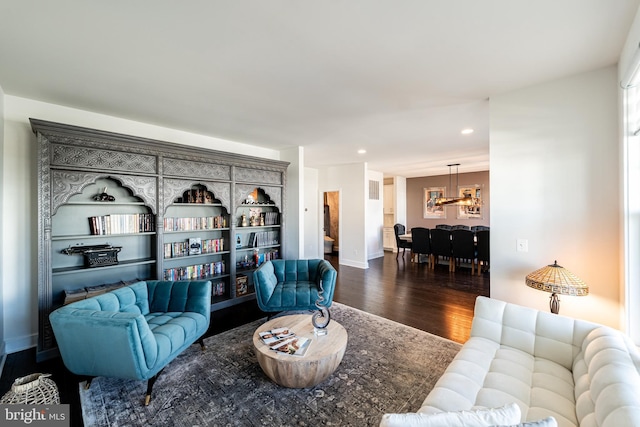 living room featuring baseboards, wood finished floors, and recessed lighting