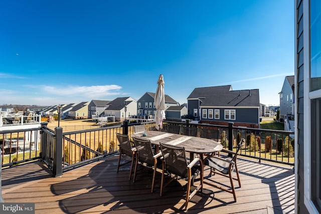 deck featuring a residential view and outdoor dining area