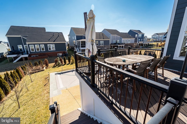 balcony with outdoor dining space and a residential view