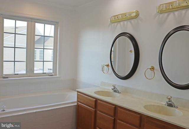 bathroom with double vanity, a garden tub, and a sink