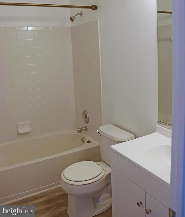 bathroom featuring vanity,  shower combination, wood finished floors, and toilet