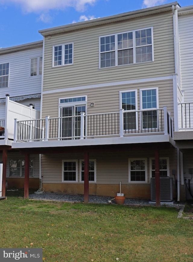 rear view of property featuring a yard and central AC unit